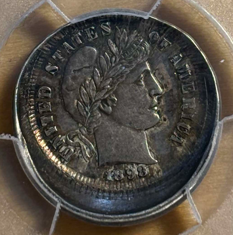 Off-center strike error on an 1898 Barber dime showing crescent-shaped unstruck area with date visible